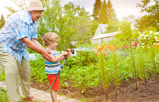 Senior and child in garden