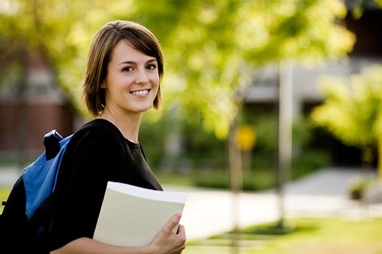 girl with backpack holding folder