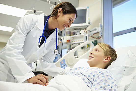 female doctor with young boy in hospital